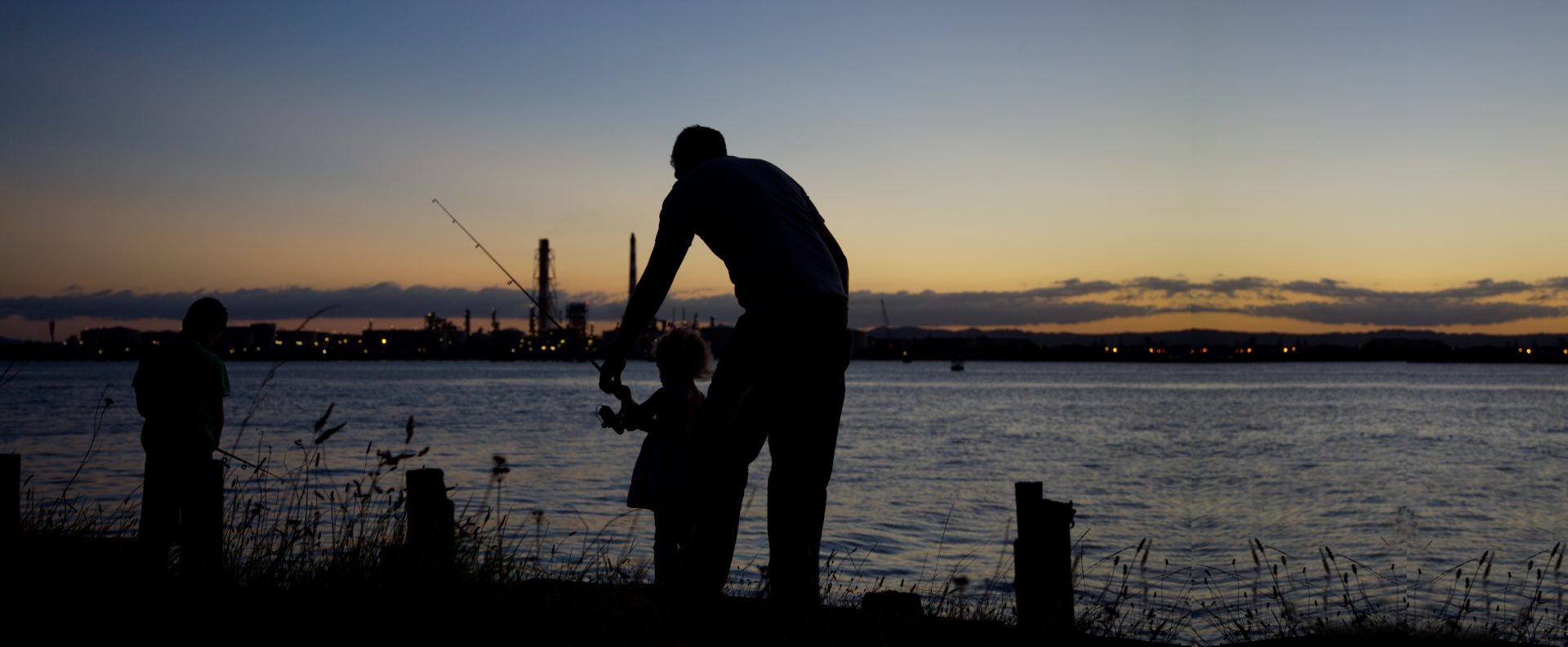 Father & Son fishing at sunset